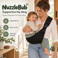 Parent supporting a toddler in the black NuzzleBub Supportive Hip Sling