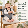 NuzzleBub Travel Chair Harness secured to a dining chair with a smiling baby